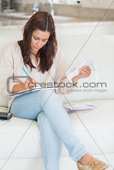 Woman holding receipts and calculating