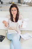 Worried woman calculating finances