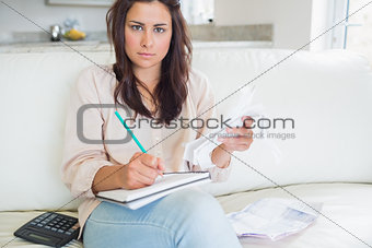 Young woman looking stressed over bills