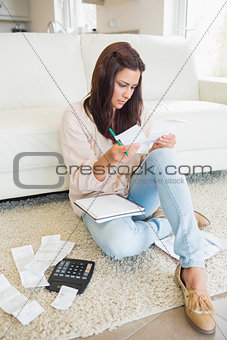 Woman checking bills in the living room