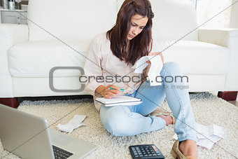 Woman checking bills on the carpet