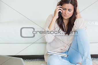 Women sitting on the carpet and calling