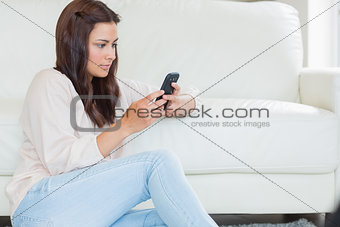 Brunette woman texting with her mobile phone