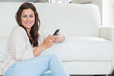 Brunette woman using her mobile phone