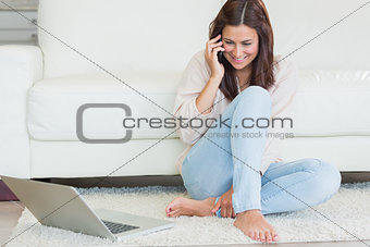 Woman calling in front of laptop