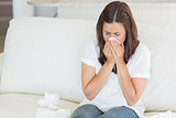 Sick woman sneezing