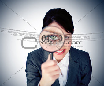 Businesswoman looking through magnifying glass
