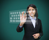 Businesswoman typing on projected digital keyboard