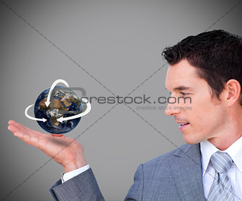 Hovering globe in Businessman's hand