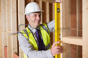 Architect measuring wood frame