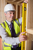 Man measuring wooden frame