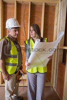 Woman and man discussing blueprints
