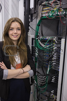 Girl standing beside rack mounted servers