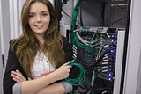 Girl holding cable in front of rack mounted servers