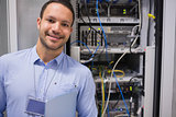 Man smiling in front of the servers