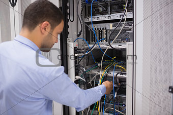 Man adjusting servers