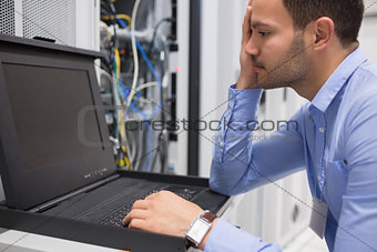 Man running diagnostics of servers