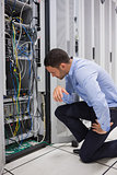 Technician looking at cables of the server