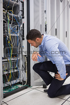 Technician looking at cables of the server