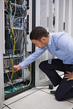 Man plugging a cable into server