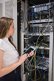 Woman with tablet pc looking at the servers