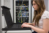 Woman running diagnostics on servers