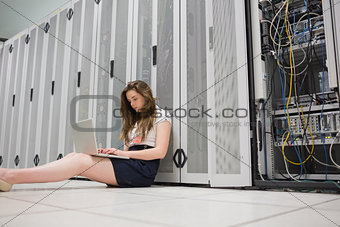 Woman sitting on floor working on laptop