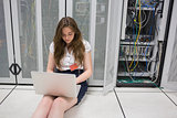 Woman working on servers sitting on the floor