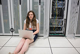 Woman checking the servers sitting on the floor
