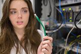 Woman looking confused at wire of server