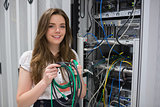 Happy woman holding server wires