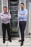 Two technicians standing in front of servers