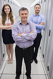 Smiling technicians standing in data center
