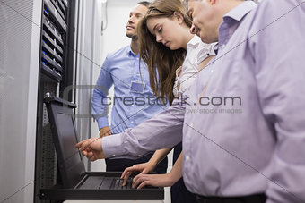 Technicians checking servers with laptop