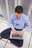 Man using his laptop in data center