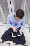 Man using tablet pc in data center