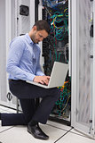 Concentrated technician doing data storage