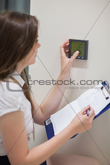 Woman setting temperature