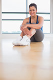 Woman sitting in fitness studio