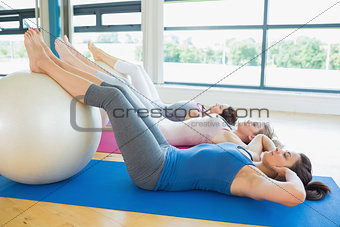 Women doing sit ups with exercise ball