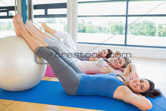 Happy women about to do sit ups