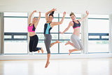 Women jumping in fitness studio