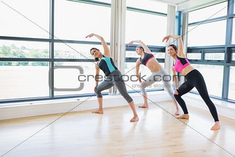Women standing at the gym stretching