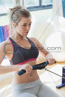 Woman pulling on row machine