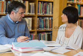 Man and woman talking in library