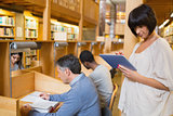 Woman holding tablet pc in the library