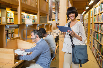 Woman holding a tablet pc with other people reading