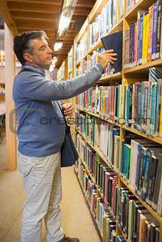 Man taking a book from the shelves