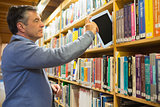 Man putting a tablet pc in the shelves