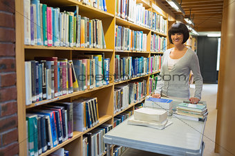 Librarian putting back books